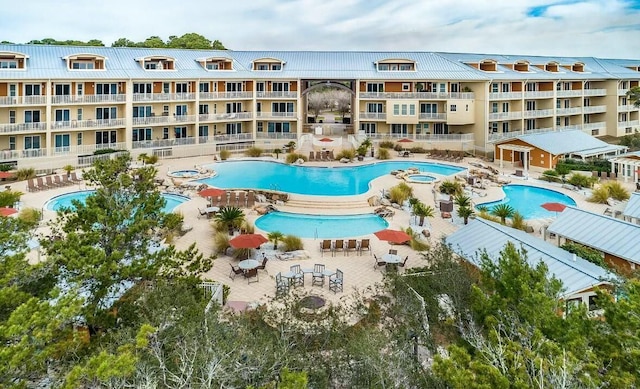 view of swimming pool with a patio area and a community hot tub