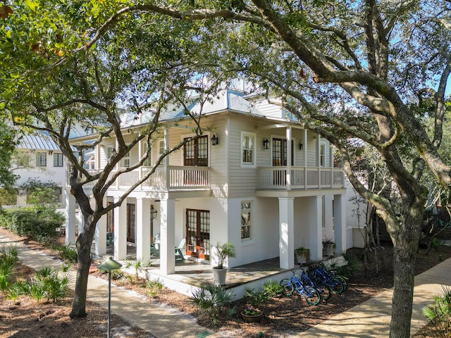 view of front of house featuring french doors and a balcony