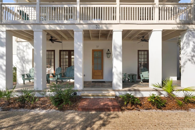 property entrance featuring ceiling fan, covered porch, and a balcony