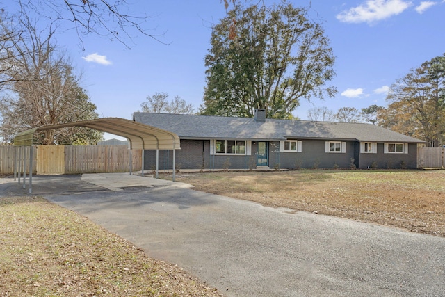 ranch-style house featuring a carport