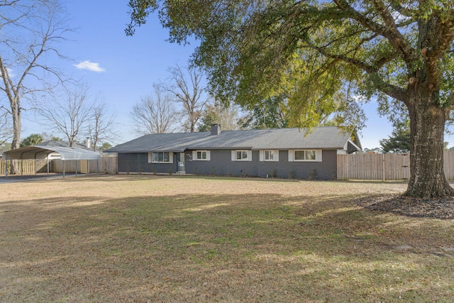 ranch-style home with a carport and a front yard