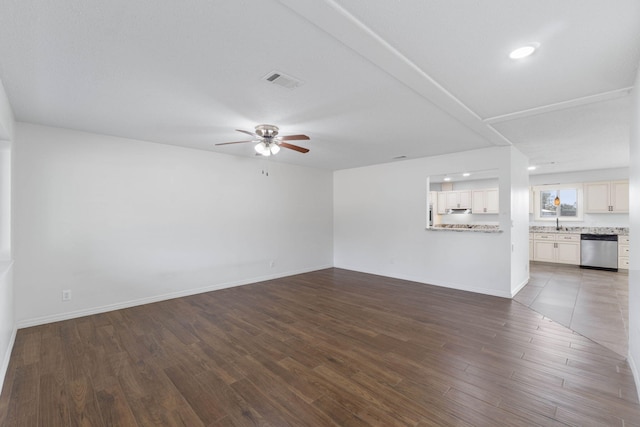 unfurnished living room featuring ceiling fan and dark hardwood / wood-style flooring