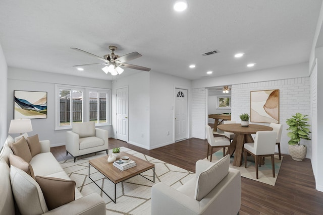 living room featuring hardwood / wood-style floors, a textured ceiling, and ceiling fan