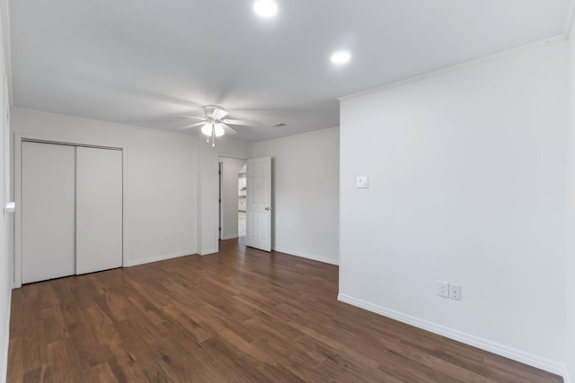 unfurnished bedroom featuring dark wood-type flooring and ceiling fan