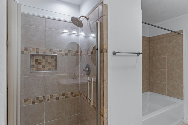 bathroom featuring a tile shower and a textured ceiling