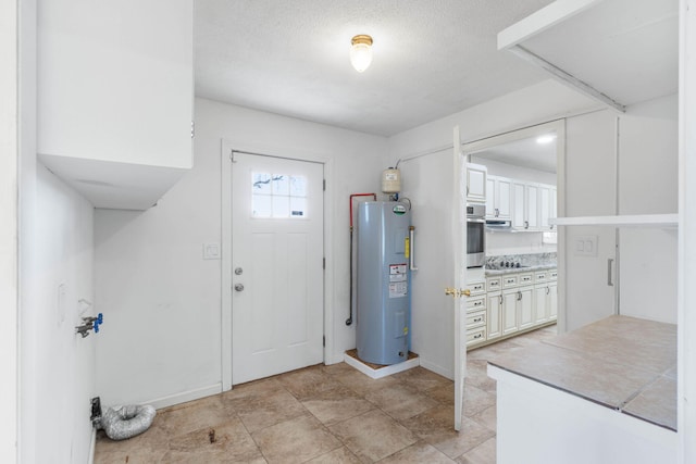 entrance foyer featuring electric water heater and a textured ceiling