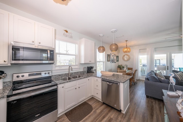 3986 W County Highway 30a Unit 231, Santa Rosa Beach, FL 32459 - kitchen with appliances with stainless steel finishes, open floor plan, white cabinets, a sink, and a peninsula