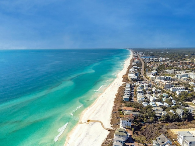 drone / aerial view with a water view and a beach view