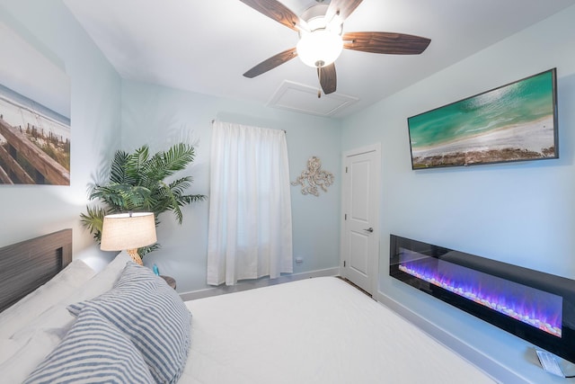 3986 W County Highway 30a Unit 231, Santa Rosa Beach, FL 32459 - bedroom featuring attic access, baseboards, ceiling fan, and a glass covered fireplace