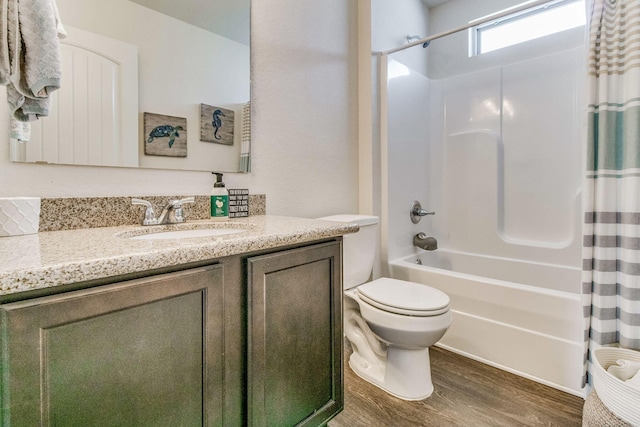 full bathroom featuring hardwood / wood-style flooring, vanity, shower / bathtub combination with curtain, and toilet