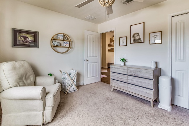 sitting room featuring light carpet and ceiling fan