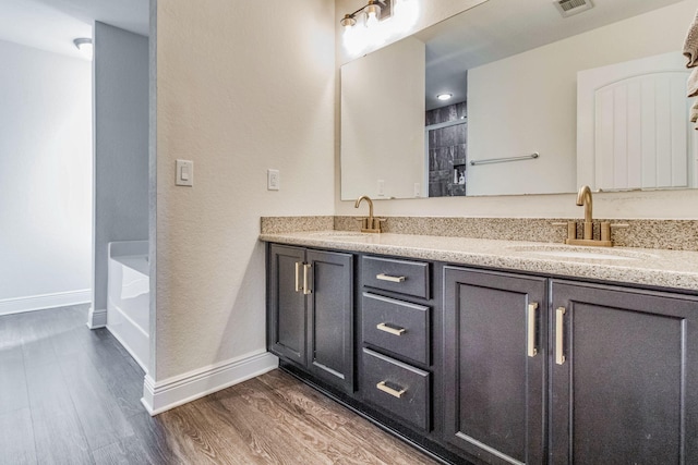 bathroom with vanity, shower with separate bathtub, and hardwood / wood-style floors