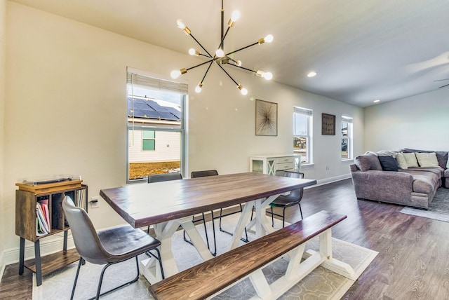 dining area featuring wood-type flooring and a chandelier