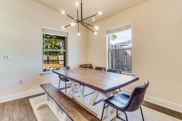 dining space featuring dark hardwood / wood-style flooring and a notable chandelier