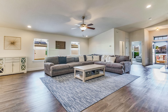 living room featuring lofted ceiling, dark hardwood / wood-style floors, and ceiling fan