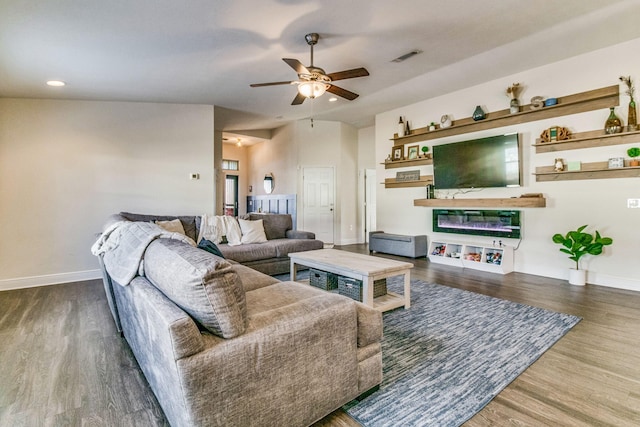 living room featuring dark hardwood / wood-style floors and ceiling fan