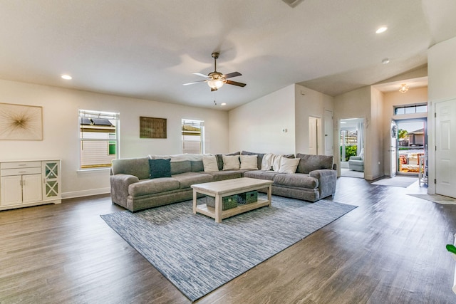 living room featuring lofted ceiling, dark hardwood / wood-style floors, and ceiling fan