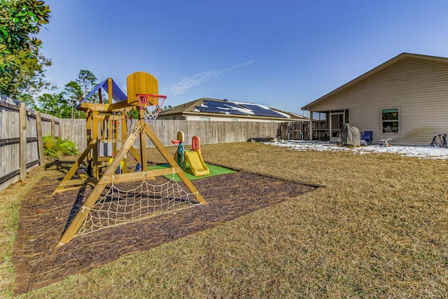 view of jungle gym featuring a patio area and a lawn