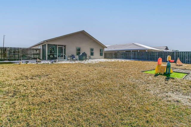 rear view of house featuring a lawn