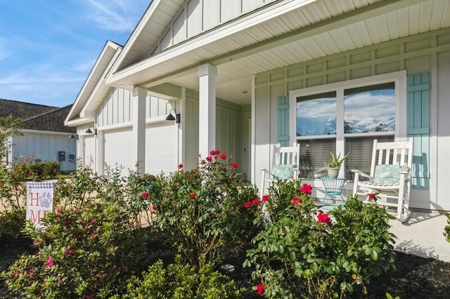 exterior space with a porch and a garage