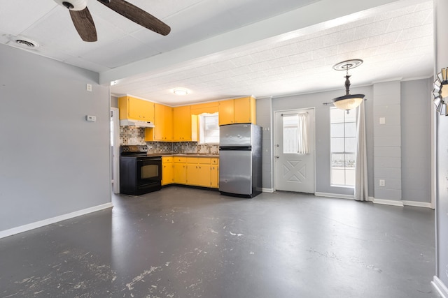 kitchen featuring black / electric stove, under cabinet range hood, visible vents, freestanding refrigerator, and decorative backsplash