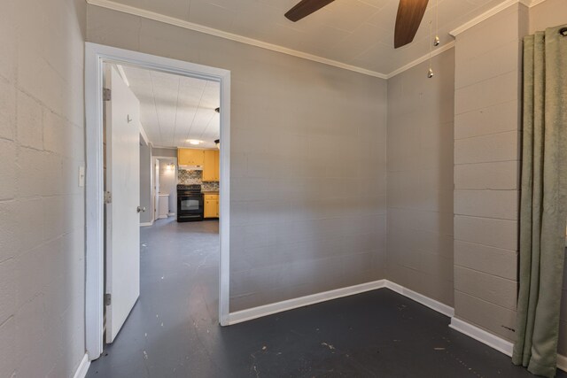 unfurnished room featuring concrete block wall, ceiling fan, concrete floors, and ornamental molding