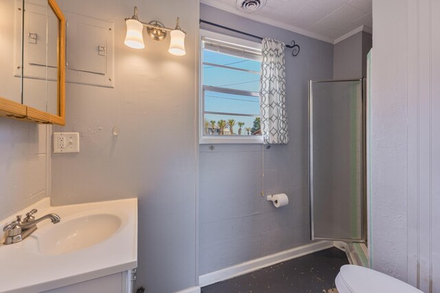 bathroom with toilet, vanity, visible vents, a shower stall, and crown molding