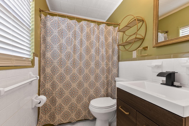 full bath with toilet, a shower with shower curtain, vanity, tile walls, and crown molding