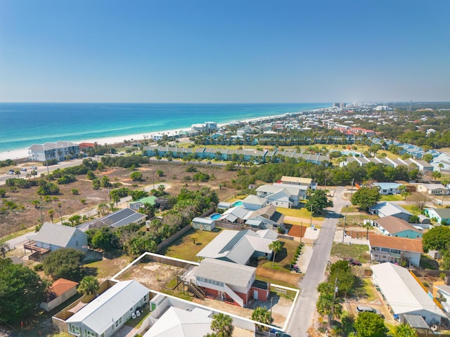 birds eye view of property featuring a water view and a beach view