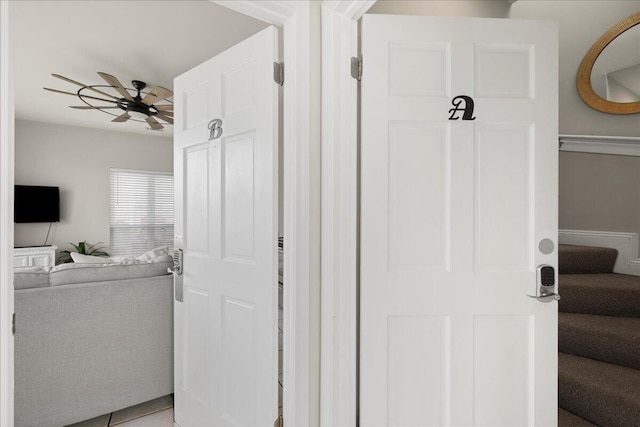 interior space featuring tile patterned floors and ceiling fan