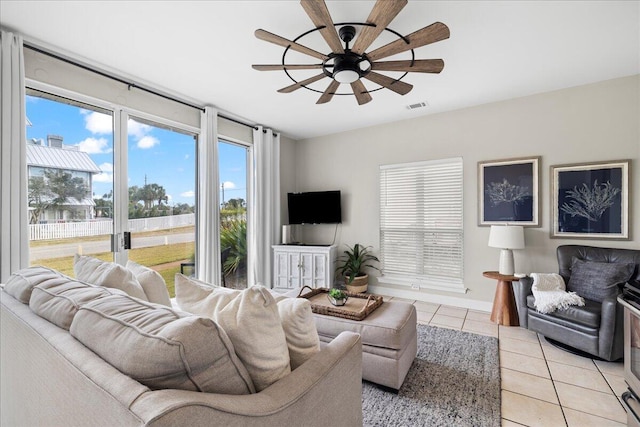 living room with light tile patterned flooring and ceiling fan