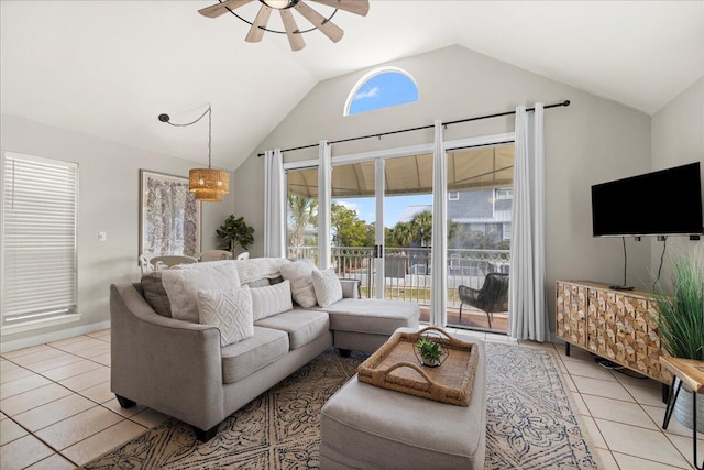 tiled living room featuring vaulted ceiling, a healthy amount of sunlight, and ceiling fan