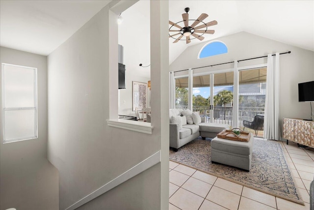 tiled living room featuring lofted ceiling and ceiling fan