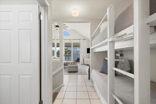 tiled bedroom featuring vaulted ceiling