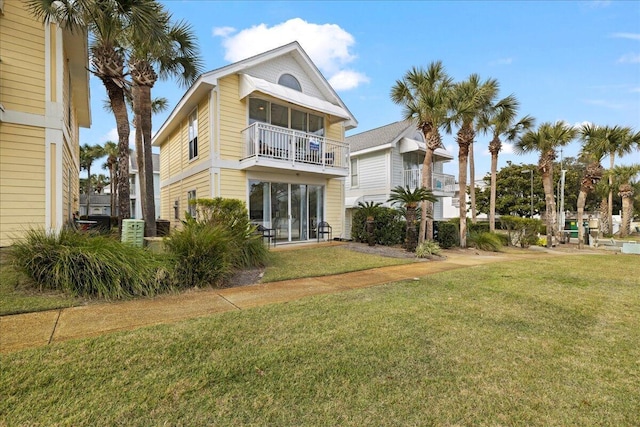 rear view of property with a yard