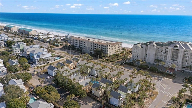 bird's eye view with a water view and a beach view