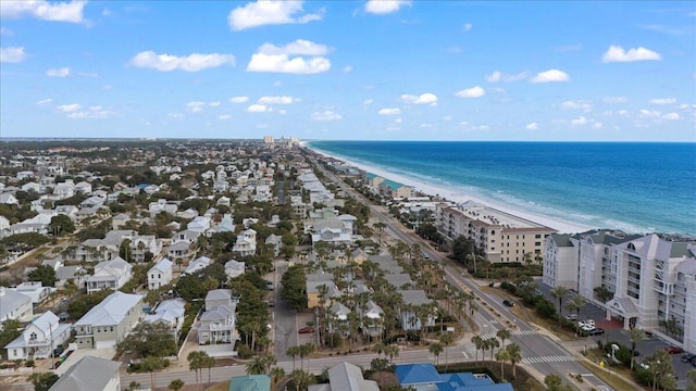 birds eye view of property with a water view and a beach view