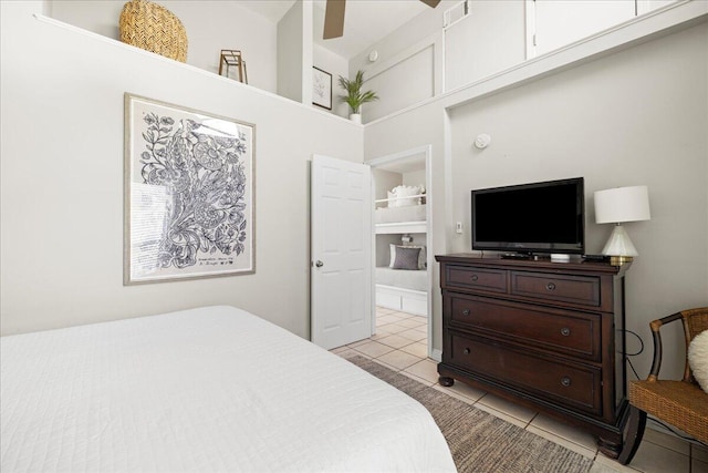 tiled bedroom featuring ceiling fan