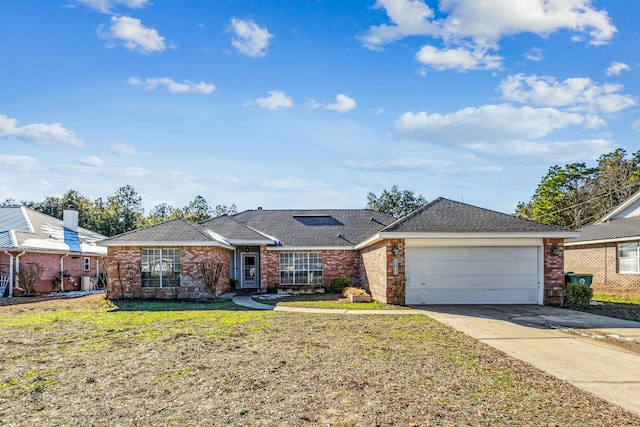 single story home featuring a garage and a front lawn