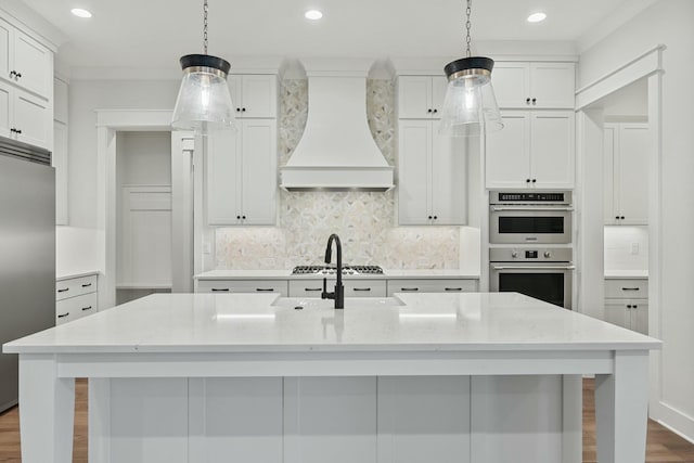 kitchen with premium range hood, stainless steel appliances, a spacious island, light stone counters, and decorative backsplash