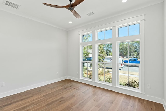 unfurnished room featuring crown molding, ceiling fan, and light hardwood / wood-style floors