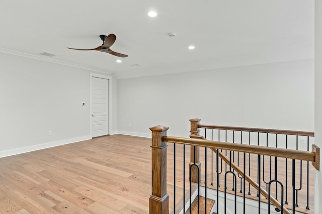 interior space featuring crown molding and light hardwood / wood-style flooring