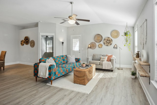 living room featuring hardwood / wood-style flooring, ceiling fan, and vaulted ceiling