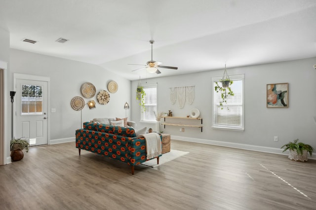 living room featuring hardwood / wood-style flooring, vaulted ceiling, and ceiling fan