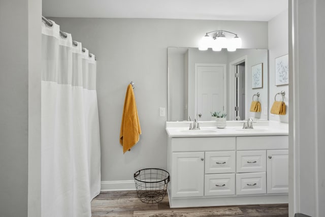 bathroom featuring vanity, curtained shower, and wood-type flooring