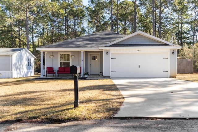 view of front of property with a garage, covered porch, and a front lawn