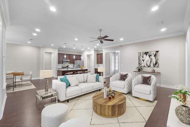 living room featuring crown molding, light hardwood / wood-style flooring, and ceiling fan