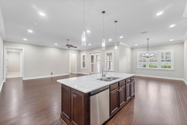 kitchen featuring dark brown cabinetry, sink, decorative light fixtures, stainless steel dishwasher, and an island with sink