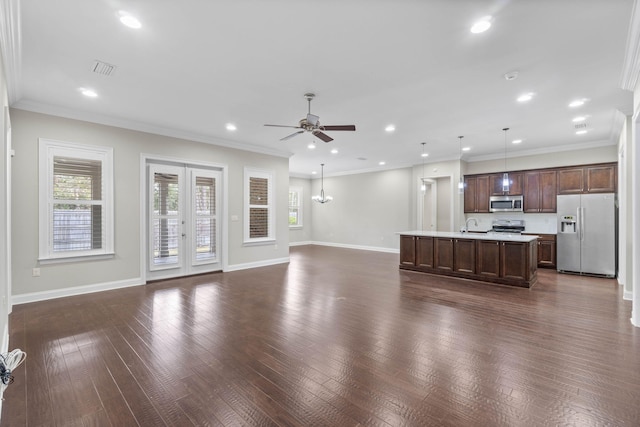 unfurnished living room featuring crown molding, dark hardwood / wood-style floors, french doors, and ceiling fan