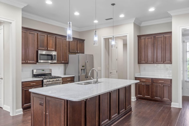 kitchen featuring appliances with stainless steel finishes, decorative light fixtures, sink, light stone countertops, and dark wood-type flooring